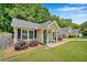Quaint single-story home with a welcoming front porch and neat landscaping along the walkway at 512 Wyndham Dr, Fuquay Varina, NC 27526