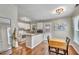 Bright kitchen with white cabinetry, granite countertops, and hardwood floors at 512 Wyndham Dr, Fuquay Varina, NC 27526