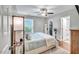 Bedroom with large window, fan, and access to ensuite bathroom and walk in closet at 512 Wyndham Dr, Fuquay Varina, NC 27526