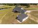Aerial view of home with back deck, fire pit and second building on property at 540 Pine Ridge Rd, Zebulon, NC 27597