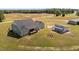 Aerial view showcasing back of home with deck, fire pit and accessory building at 540 Pine Ridge Rd, Zebulon, NC 27597