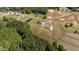 An aerial view showcases homes surrounded by lush greenery and cultivated farmland at 540 Pine Ridge Rd, Zebulon, NC 27597