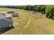 Expansive backyard featuring a fire pit area, open lawn, and a treeline in a private setting at 540 Pine Ridge Rd, Zebulon, NC 27597