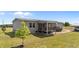 Inviting backyard with a screened-in porch, a small tree, and a carport at 540 Pine Ridge Rd, Zebulon, NC 27597