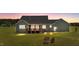 Exterior backyard showcasing a wooden deck and fire pit area for entertaining at 540 Pine Ridge Rd, Zebulon, NC 27597