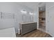 Modern bathroom with dual sinks, a vanity with marble countertops, and a glass door shower at 540 Pine Ridge Rd, Zebulon, NC 27597