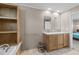 Bright bathroom with double vanity, soaking tub, and open shelving for ample storage at 540 Pine Ridge Rd, Zebulon, NC 27597