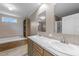 Elegant bathroom with double sinks, wood paneled accent wall, separate tub, and bright, natural light at 540 Pine Ridge Rd, Zebulon, NC 27597