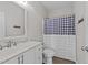 Clean bathroom with white vanity, framed mirror, and shower with checkered curtains at 540 Pine Ridge Rd, Zebulon, NC 27597