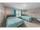 Bright bedroom featuring two twin beds, a window view, and simple, modern decor at 540 Pine Ridge Rd, Zebulon, NC 27597
