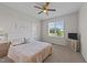 Cozy bedroom with ceiling fan, plush carpet, and bright natural light from a large window at 540 Pine Ridge Rd, Zebulon, NC 27597