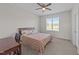 Bright bedroom featuring a ceiling fan, carpet, and a window overlooking the greenery at 540 Pine Ridge Rd, Zebulon, NC 27597