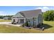 Exterior view showcasing the home's covered porch and landscaped front yard at 540 Pine Ridge Rd, Zebulon, NC 27597