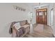 Entryway featuring wood floors, coat rack, bench and natural wood door at 540 Pine Ridge Rd, Zebulon, NC 27597