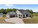 Aerial view of home showing a covered porch with stone columns and a well-manicured front yard at 540 Pine Ridge Rd, Zebulon, NC 27597