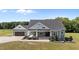 Charming home showcasing a covered porch with stone columns and a well-manicured front yard at 540 Pine Ridge Rd, Zebulon, NC 27597