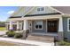 Front porch with stone accents, wooden door and welcoming entrance steps at 540 Pine Ridge Rd, Zebulon, NC 27597