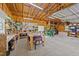 Well-lit garage featuring exposed framing, pegboard organizing system, and spacious workbenches at 540 Pine Ridge Rd, Zebulon, NC 27597