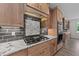 Modern kitchen features stainless steel appliances, dark backsplash, and granite countertops at 540 Pine Ridge Rd, Zebulon, NC 27597