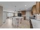 Bright kitchen with island seating, stainless appliances, and an open flow to the living area at 540 Pine Ridge Rd, Zebulon, NC 27597