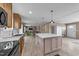 Bright kitchen featuring a large island with marble countertops, wooden cabinetry, and modern appliances at 540 Pine Ridge Rd, Zebulon, NC 27597