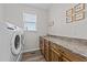 Practical laundry room with modern washer and dryer, sink, and ample counter space at 540 Pine Ridge Rd, Zebulon, NC 27597