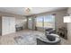 Cozy living room with ample seating, stylish rug, and bright natural light at 540 Pine Ridge Rd, Zebulon, NC 27597
