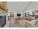 Open-concept living room showcases a stone fireplace, hardwood floors, and seamless kitchen access at 540 Pine Ridge Rd, Zebulon, NC 27597