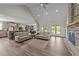 Spacious living room featuring a stone fireplace, hardwood floors, and access to the outdoor deck at 540 Pine Ridge Rd, Zebulon, NC 27597