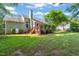 Backyard view with a deck, mature trees, privacy fence and a propane tank, perfect for outdoor living at 5441 Millrace Trl, Raleigh, NC 27606