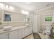 Bright bathroom with double sinks, granite countertops, and glass-enclosed shower at 5441 Millrace Trl, Raleigh, NC 27606
