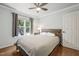 Cozy bedroom with hardwood floors, neutral paint, and natural light from a large window at 5441 Millrace Trl, Raleigh, NC 27606