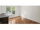 This bedroom offers hardwood floors and a large window at 5441 Millrace Trl, Raleigh, NC 27606