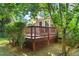 Backyard deck perfect for quiet moments amongst the trees, with lattice trim and backyard access at 5441 Millrace Trl, Raleigh, NC 27606