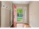 Inviting foyer with hardwood floors and a bright red door leading to a view of the neighborhood at 5441 Millrace Trl, Raleigh, NC 27606