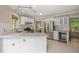 Bright kitchen with stainless steel appliances, white cabinets, granite countertops, and tile backsplash at 5441 Millrace Trl, Raleigh, NC 27606