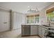Bright kitchen featuring granite countertops, stainless steel appliances, and white cabinets for a modern feel at 5441 Millrace Trl, Raleigh, NC 27606