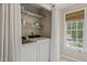 Bright laundry room featuring a washer, dryer, storage shelves, and a window for natural light at 5441 Millrace Trl, Raleigh, NC 27606