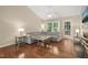 Spacious living room featuring hardwood floors, vaulted ceiling, and a comfortable gray sectional sofa near large windows at 5441 Millrace Trl, Raleigh, NC 27606