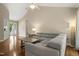 Comfortable living room with vaulted ceiling, hardwood floors, large windows, and gray sectional seating at 5441 Millrace Trl, Raleigh, NC 27606