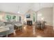 Bright living room with hardwood floors, a fireplace, vaulted ceilings, and a gray sectional sofa at 5441 Millrace Trl, Raleigh, NC 27606