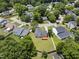 Aerial view of the home showcasing the backyard, deck, neighborhood, and mature trees at 5529 Wood Pond Ct, Raleigh, NC 27610