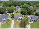 Expansive aerial view of a house with a large backyard and surrounding mature trees at 5529 Wood Pond Ct, Raleigh, NC 27610