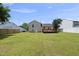 Large backyard featuring a well-maintained lawn, a stained wood deck and a privacy fence at 5529 Wood Pond Ct, Raleigh, NC 27610