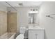 Bathroom featuring a tiled shower and bathtub, toilet, vanity with sink and a mirror at 5529 Wood Pond Ct, Raleigh, NC 27610