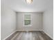 Bedroom featuring neutral walls, wood-look flooring, and a window offering natural light at 5529 Wood Pond Ct, Raleigh, NC 27610