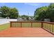 View of the wooden deck overlooking the backyard and lawn at 5529 Wood Pond Ct, Raleigh, NC 27610