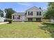 Charming two-story home with a well-manicured front yard and classic curb appeal at 5529 Wood Pond Ct, Raleigh, NC 27610