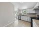 Bright kitchen with white cabinets, stainless steel appliances, and eat-in area at 5529 Wood Pond Ct, Raleigh, NC 27610