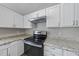 Kitchen features white cabinets, stainless steel appliances, and granite countertops at 5529 Wood Pond Ct, Raleigh, NC 27610